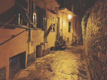 Street amidst buildings at night