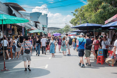 People on street market against sky