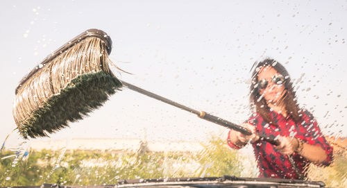 Woman jumping on water against clear sky