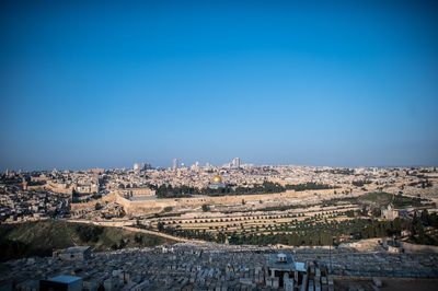 High angle view of townscape against clear blue sky