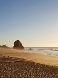 Scenic view of beach against clear sky