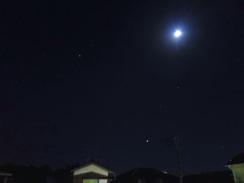 Low angle view of moon against clear sky at night