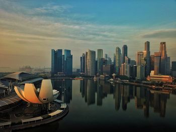 View of river against city during sunset