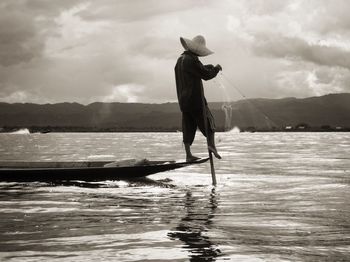 Full length of man standing on sea against sky