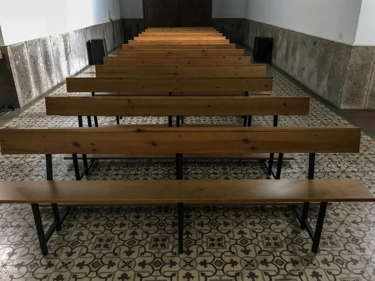 EMPTY BENCH ON TABLE AGAINST WALL