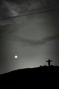 Low angle view of silhouette trees against sky at dusk