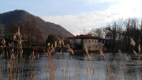 Scenic view of lake by building against sky