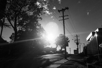 Street amidst trees against sky in city