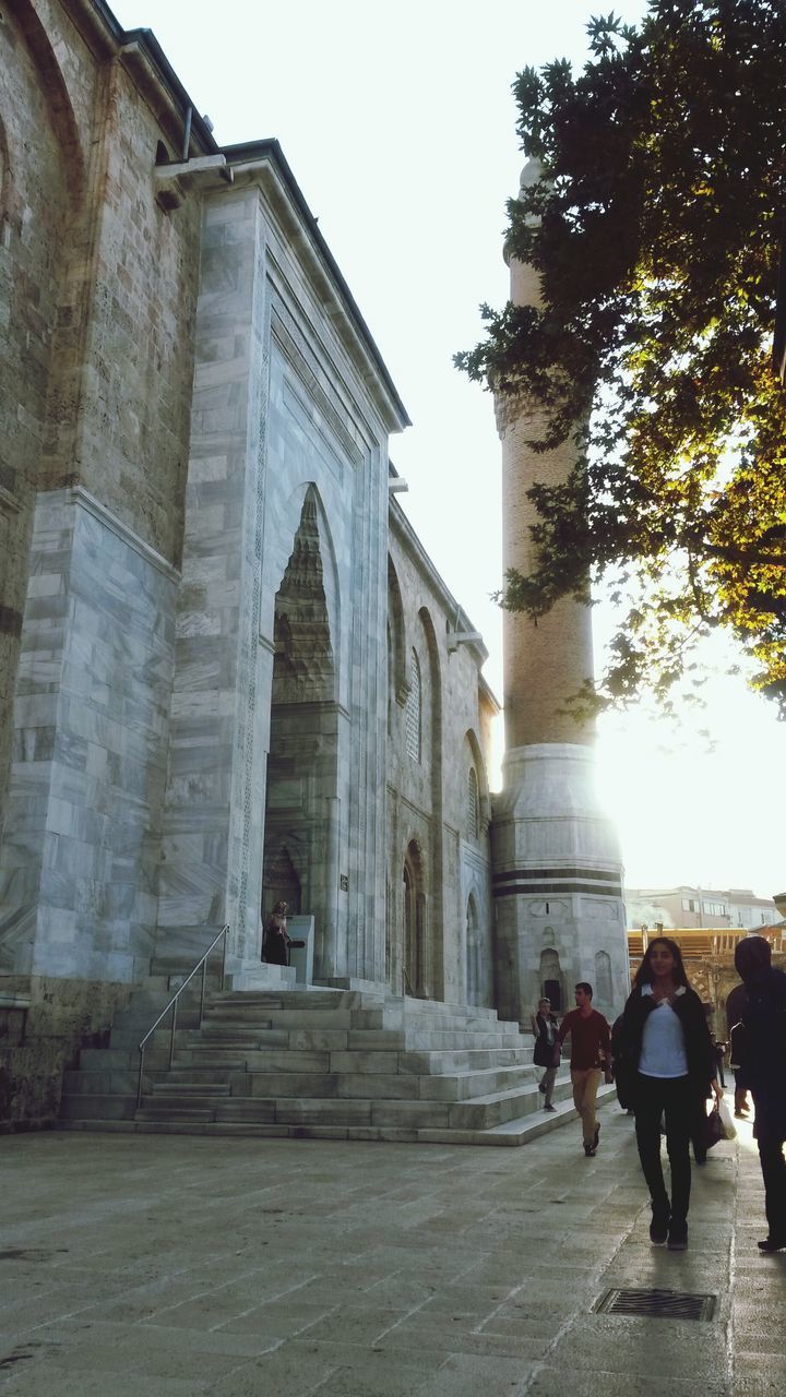 architecture, built structure, building exterior, person, men, lifestyles, leisure activity, walking, large group of people, clear sky, tree, day, sky, tourist, steps, outdoors, sunlight, full length, city