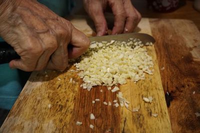 Close-up of person preparing food on cutting board