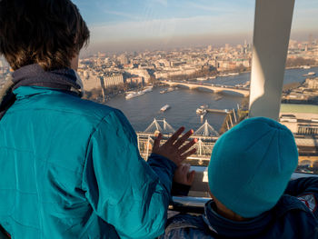 Rear view of man looking at cityscape