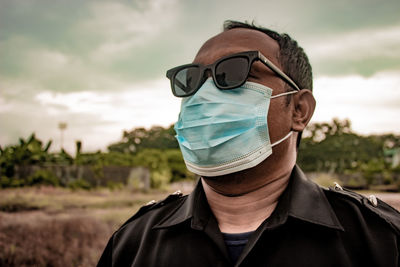 Portrait of man wearing sunglasses against sky