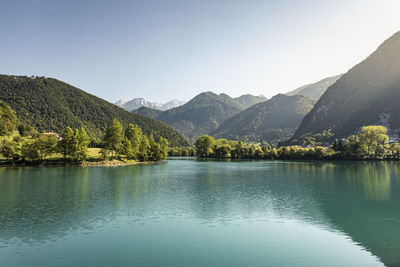 Scenic view of lake and mountains against clear sky