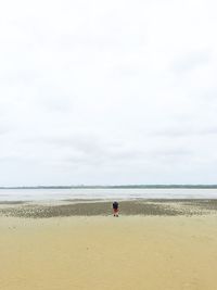 Man on beach against sky