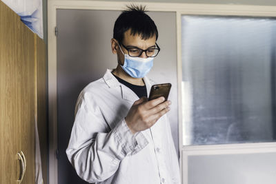 Male scientist using smartphone portrait