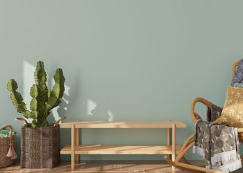 Empty light green wall in modern living room. mock up interior in scandinavian, boho style. 