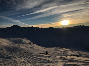 Scenic view of snowcapped mountains against sky during sunset