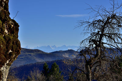 Scenic view of mountains against blue sky