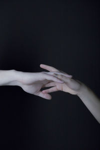 Close-up of hands over black background