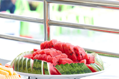 Close-up of chopped fruits in glass window