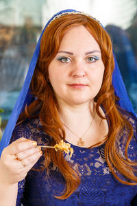 Portrait of beautiful woman holding camera