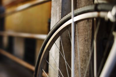 Close-up of bicycle wheel against wall