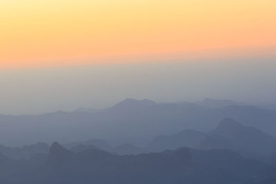 Scenic view of silhouette mountains against sky during sunset