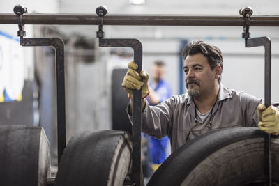 Tire repairer adjusting hooks on tires