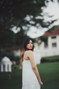 Portrait of a smiling young woman standing outdoors