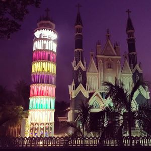 Low angle view of illuminated building against sky at night