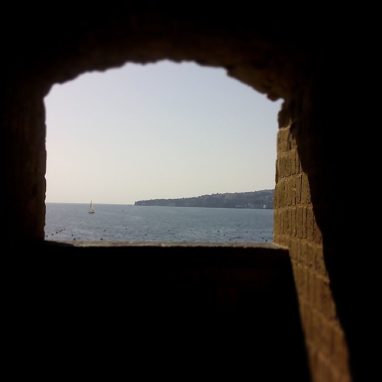 SCENIC VIEW OF BEACH AGAINST SKY SEEN THROUGH ARCH