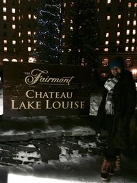 Full length of woman standing in city during winter