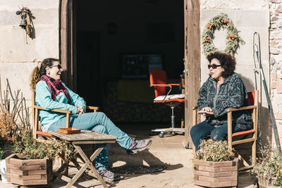 Female laughing and talking while sitting outdoors