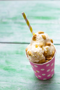 Ice cream in disposable cup on table