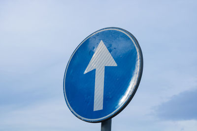 Low angle view of road sign against sky