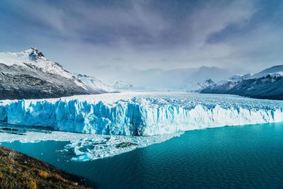 Scenic view of lake against sky during winter