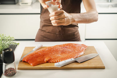 Cropped hand of person preparing food