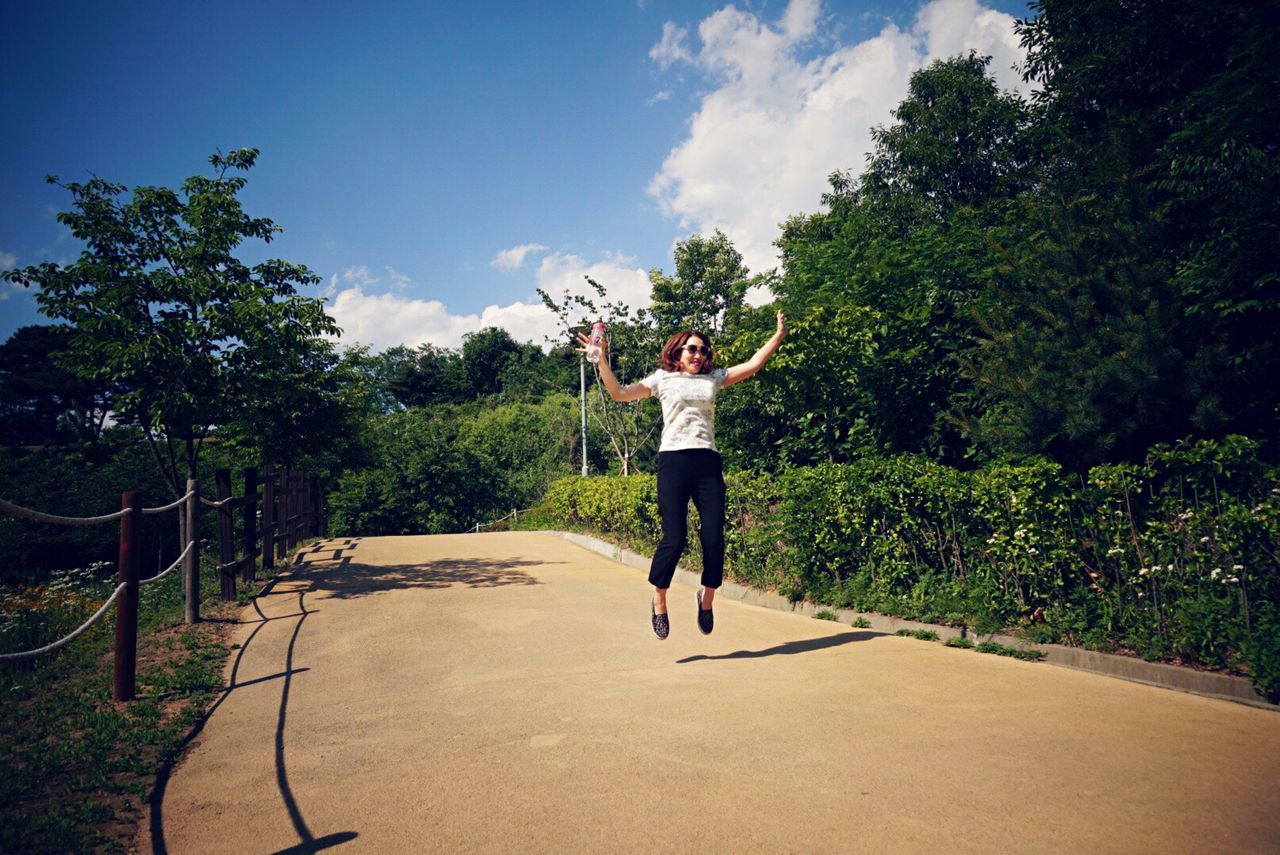 WOMAN PLAYING AGAINST SKY