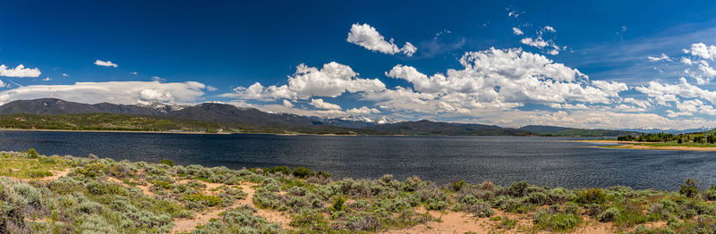 Scenic view of sea and mountains against sky