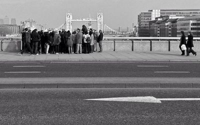 People walking on road in city