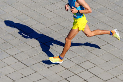 Low section of woman walking on footpath