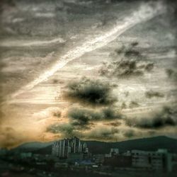 Cloudy sky above city at sunset