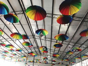 Low angle view of multi colored umbrellas hanging