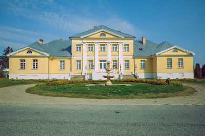 Building by road against sky