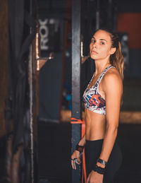 Midsection of woman standing against wall