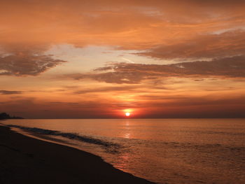 Scenic view of sea against orange sky