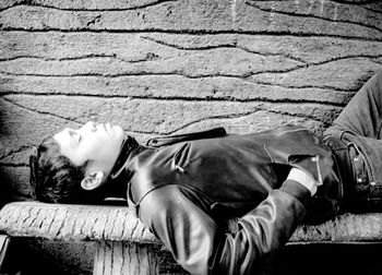 Man sleeping on wall