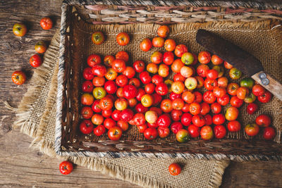 Cherry tomatoes in basket on table