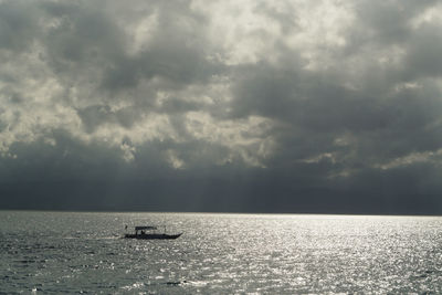 Scenic view of sea against storm clouds