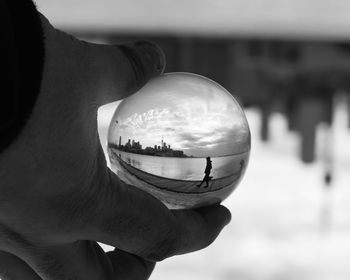 Close-up of hand holding crystal ball